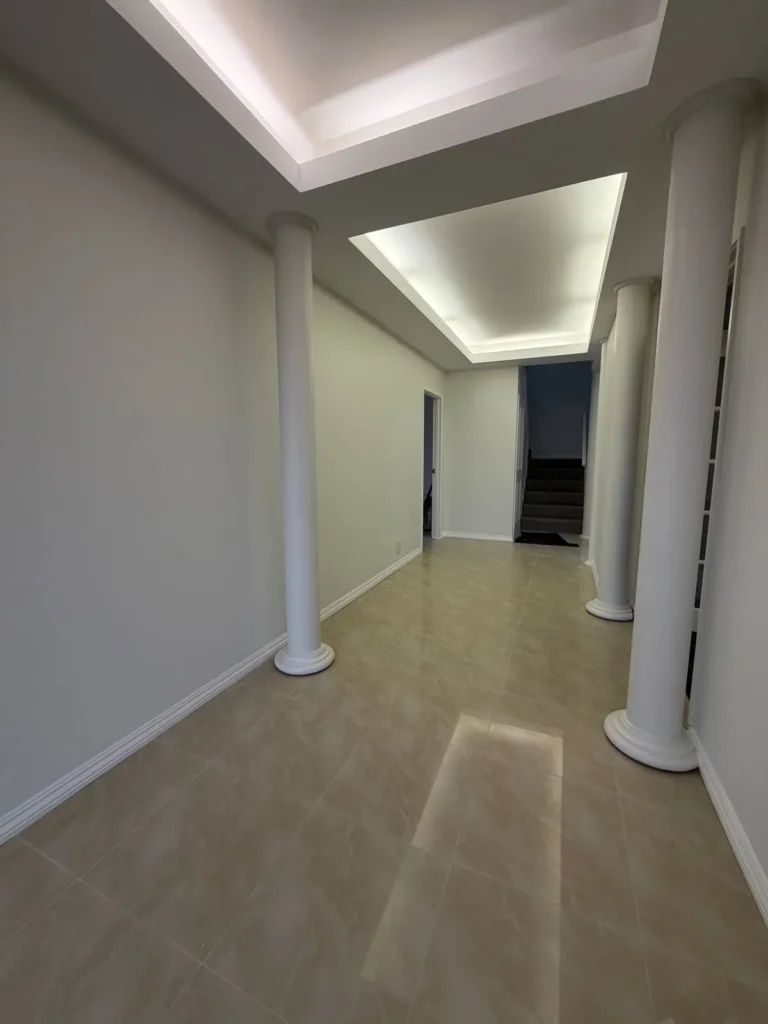 Repainted entry hall with white columns and a recessed lit ceiling in a Canning Vale home