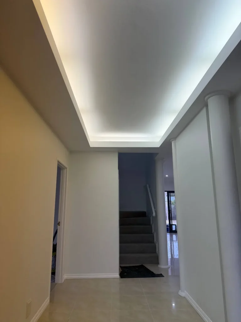 Freshly painted hallway with an LED cove ceiling leading to the staircase in a Canning Vale home