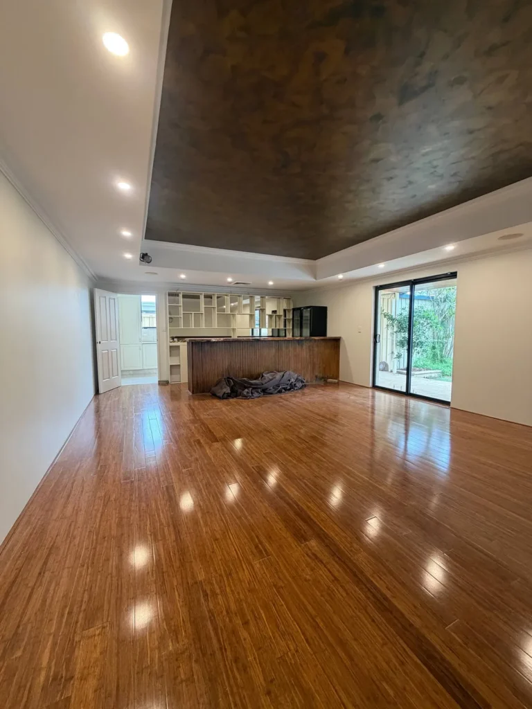 Repainted open-plan living area with timber floors and a feature tray ceiling in a Canning Vale home
